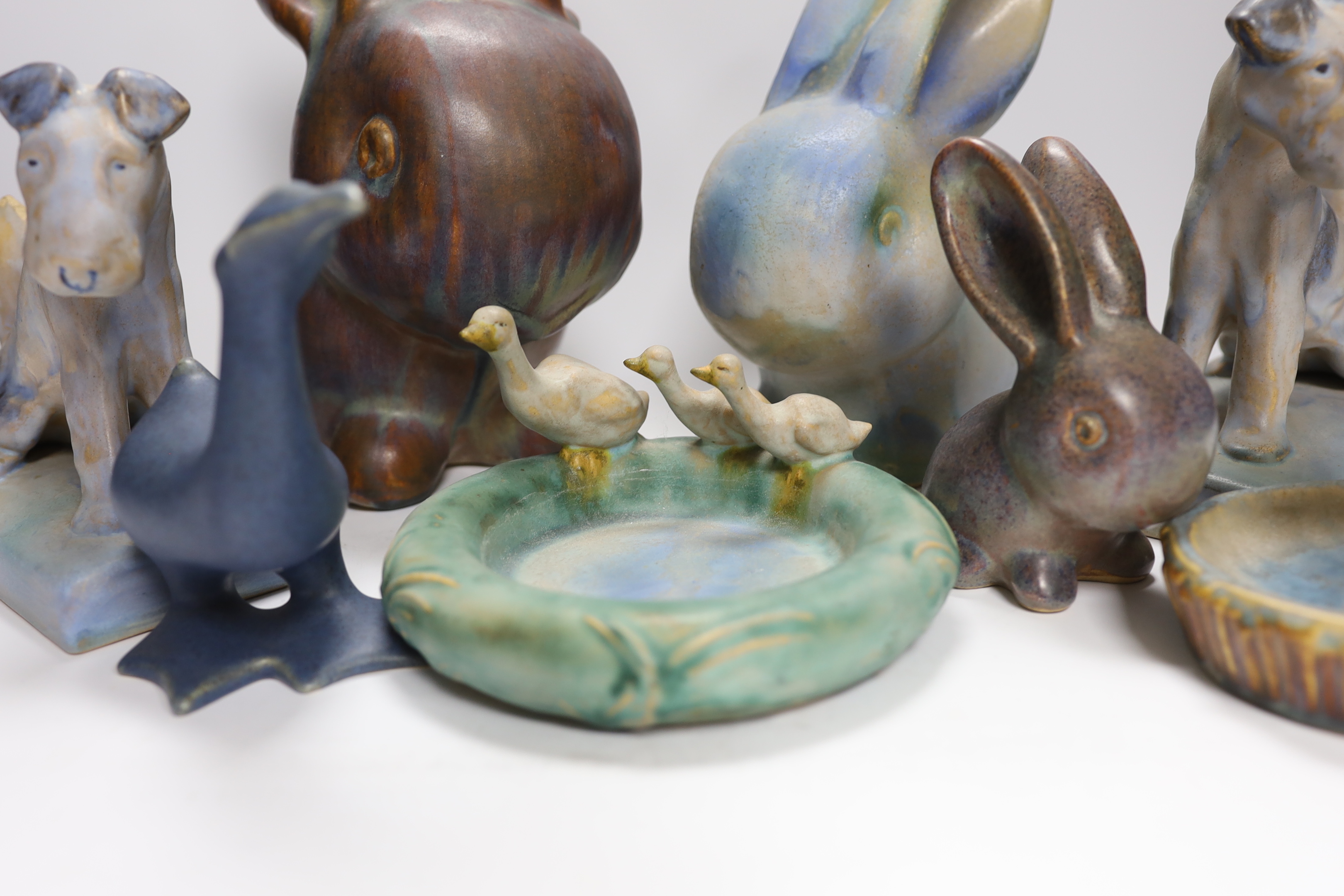 Collection of Bourne Denby animals including rabbits and a pair of dogs, tallest 27cm